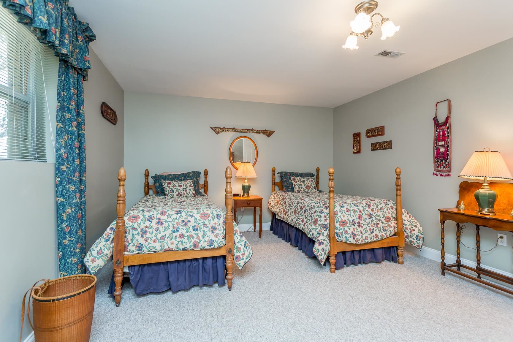 6403 Spring Hill Road Bridgewater, VA 22812 - Photo 33 of 52 a bedroom with bed and a chandelier