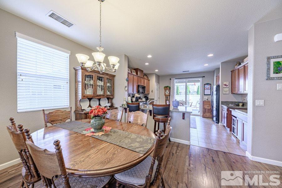11048 Colton Drive Reno, NV 89521 - Photo 8 of 23 a view of a dining room with furniture window and wooden floor