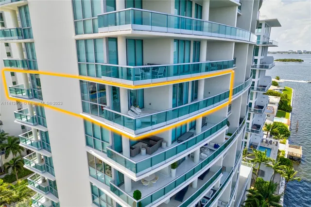 a bedroom with bed and a flat tv screen on dresser