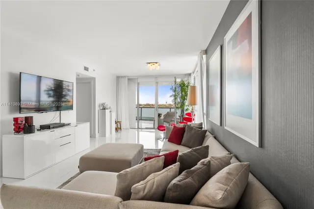 a living room filled with furniture and a potted plant