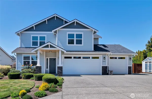 a front view of a house with a yard and garage