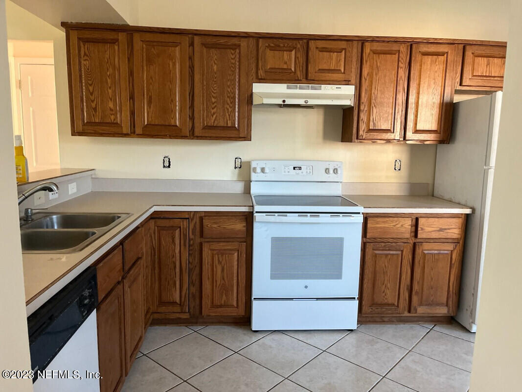 2805 Unison Court Middleburg, FL 32068 - Photo 2 of 6 a kitchen with a stove sink and cabinets