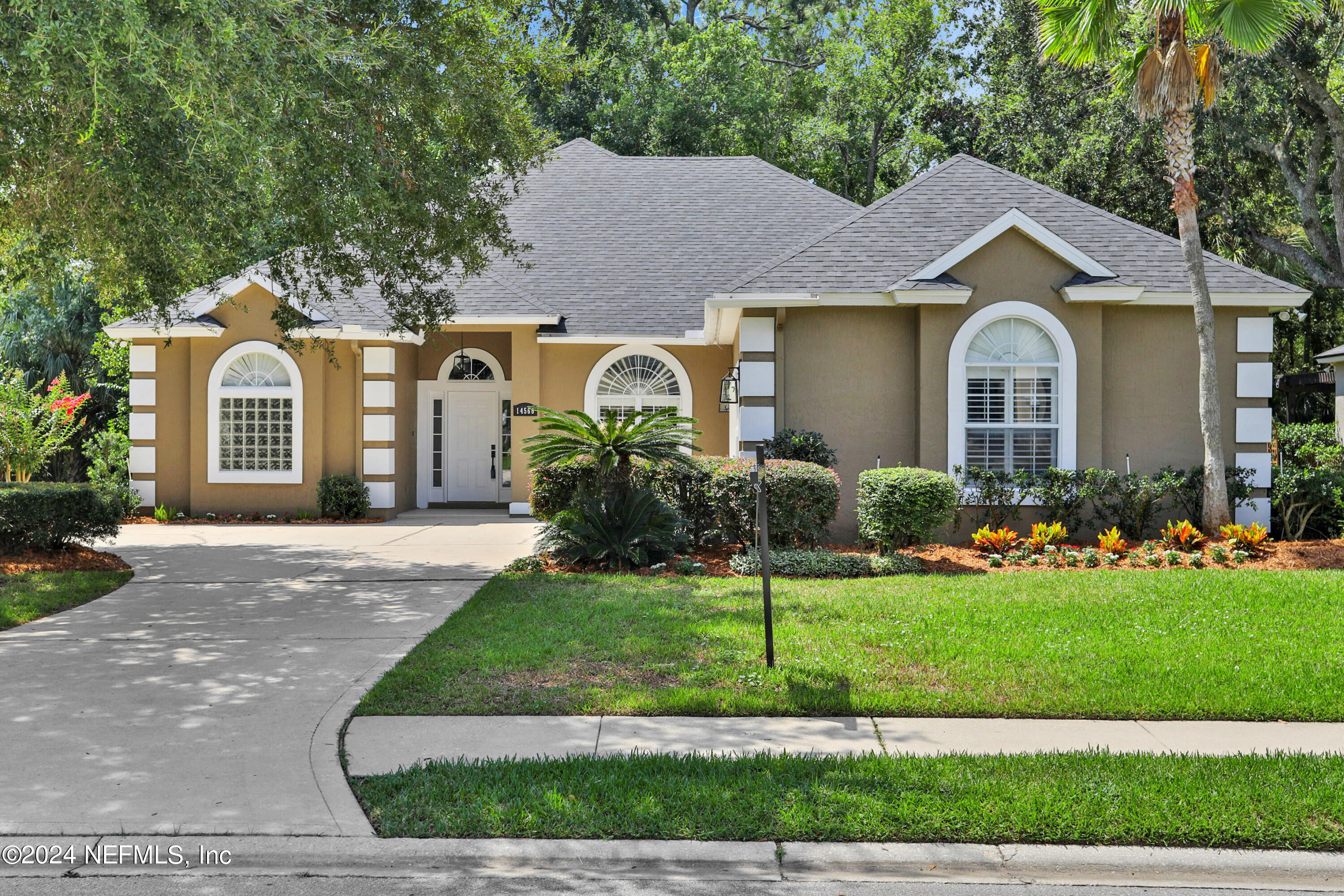 14566 Marsh View Drive Jacksonville, FL 32250 - Photo 1 of 26 a front view of a house with a garden