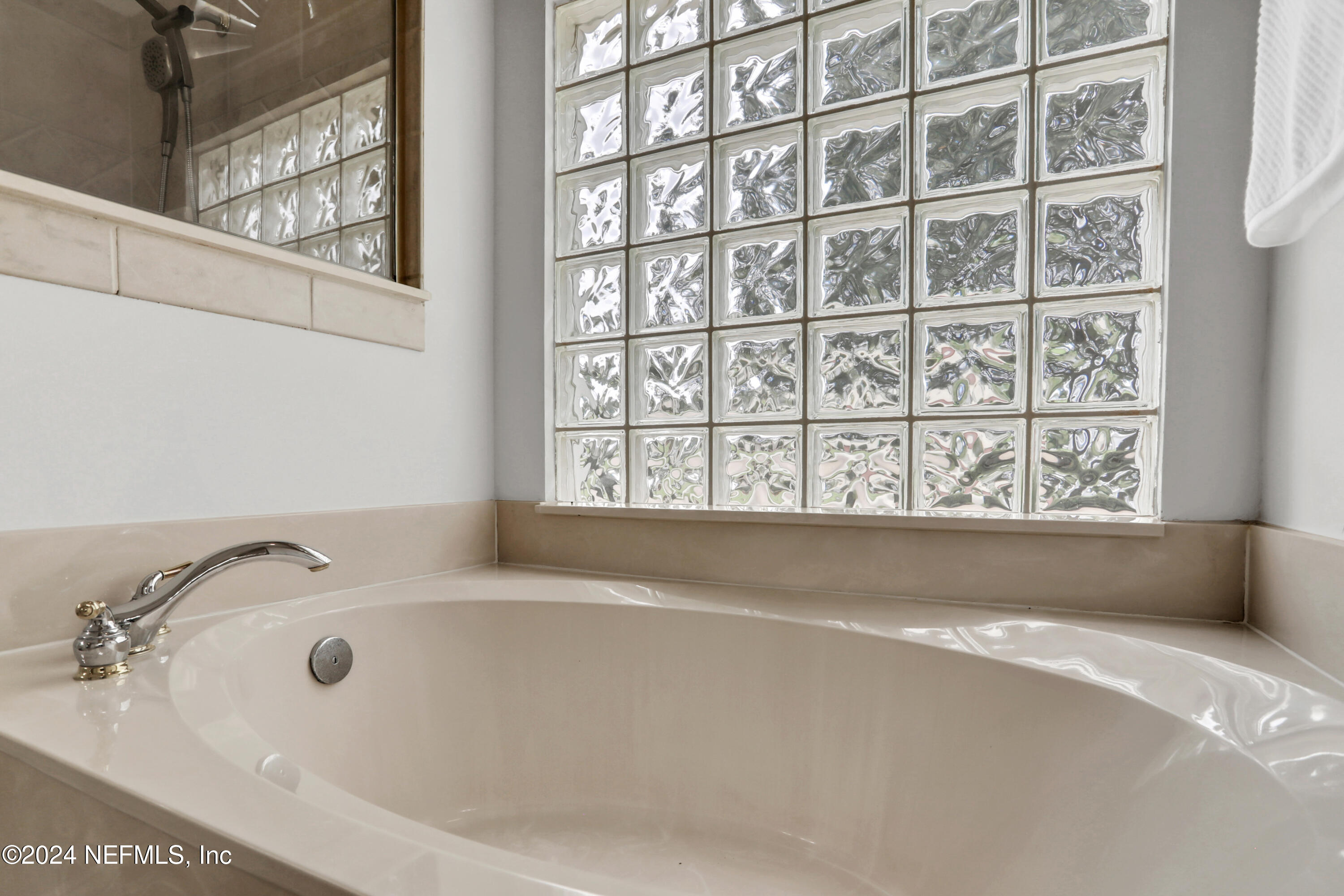 14566 Marsh View Drive Jacksonville, FL 32250 - Photo 15 of 26 a bathroom with a bathtub and next to a window