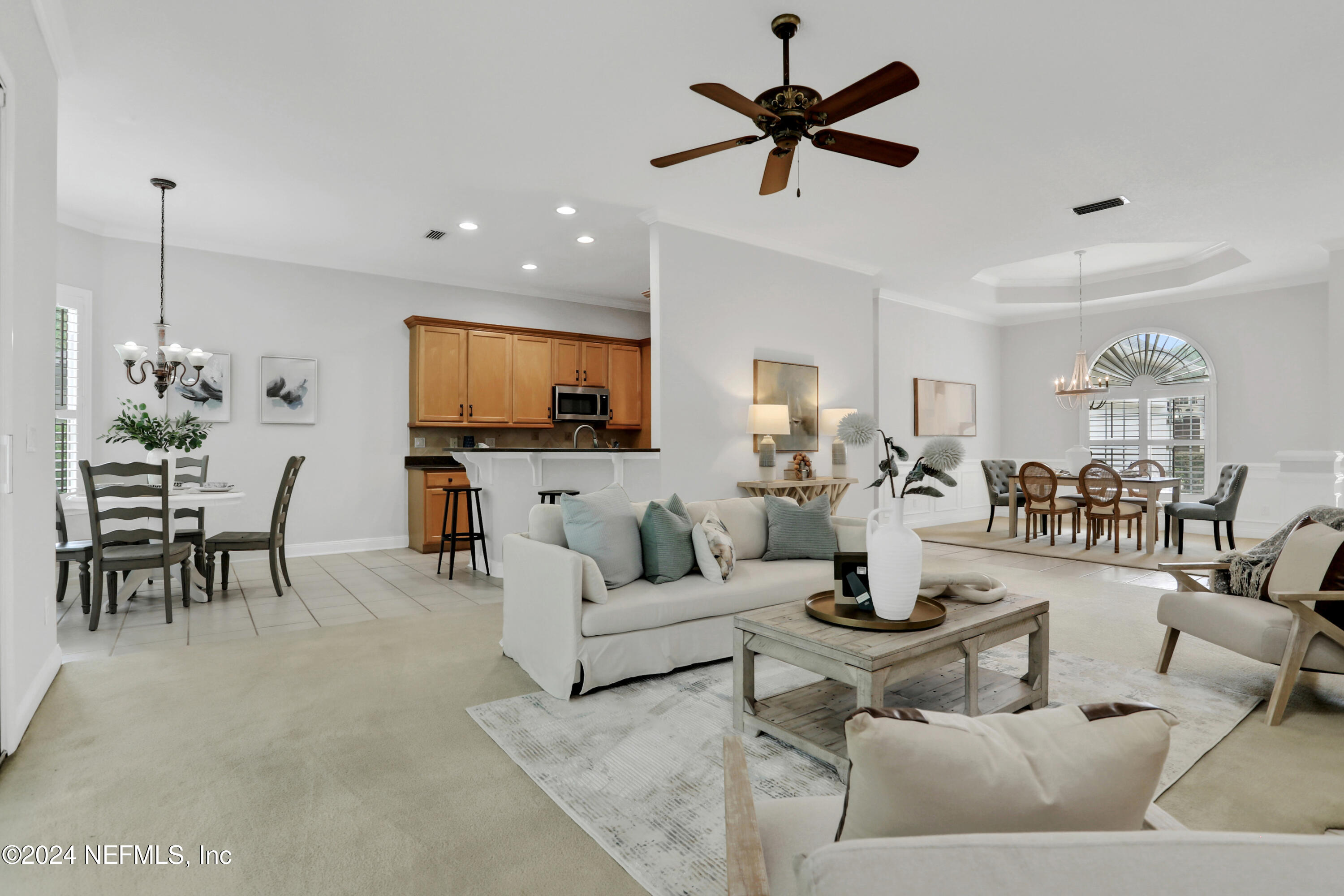 14566 Marsh View Drive Jacksonville, FL 32250 - Photo 2 of 26 a living room with furniture a dining table and a fireplace