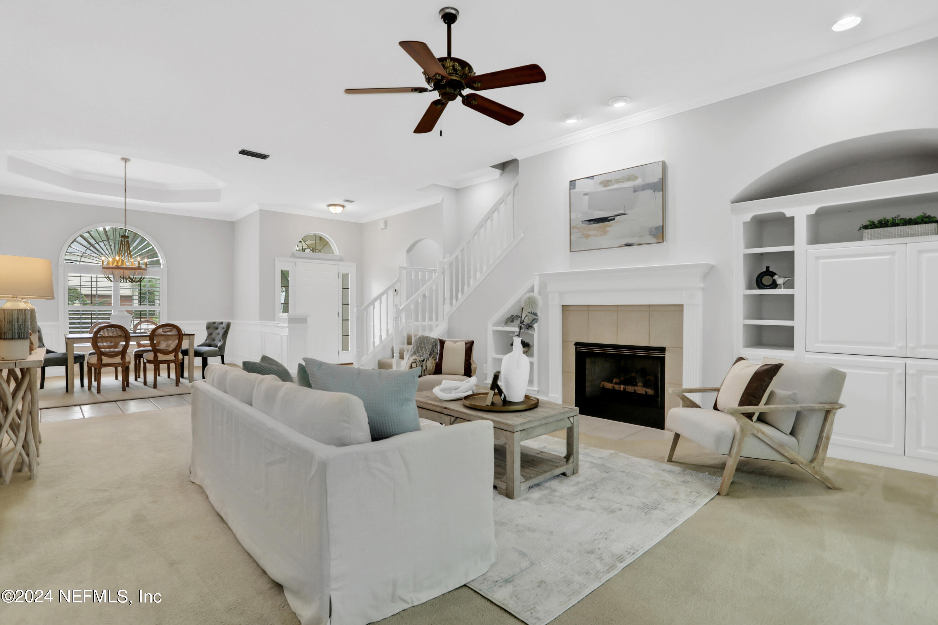14566 Marsh View Drive Jacksonville, FL 32250 - Photo 3 of 26 a living room with furniture a fireplace and a chandelier