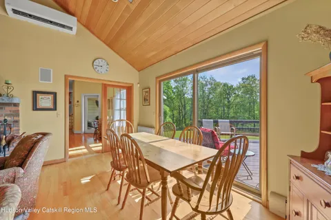 a kitchen with stainless steel appliances granite countertop a stove a sink a refrigerator dining table and chairs