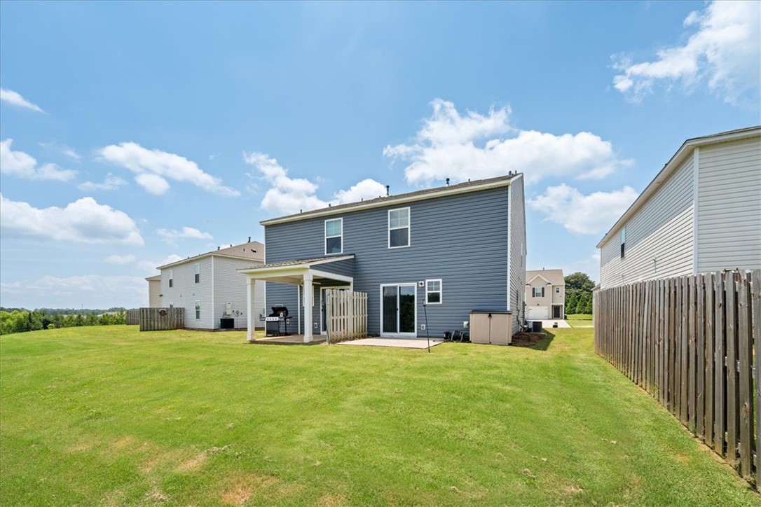 115 Adger Road Pendleton, SC 29670 - Photo 35 of 36 A spacious backyard provides ample green space and a covered patio perfect for outdoor entertaining.