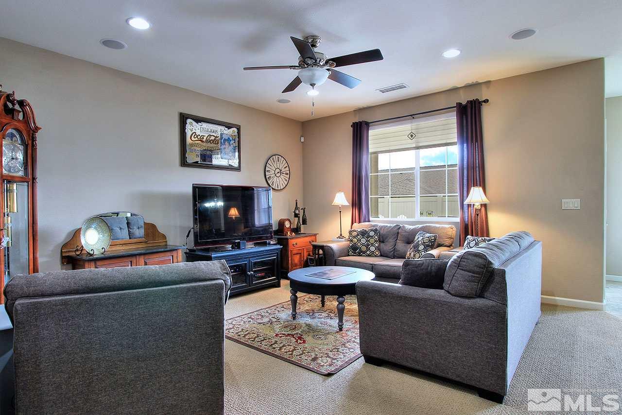9655 Aidan Way Reno, NV 89521 - Photo 5 of 25 a living room with furniture a fireplace and a flat screen tv
