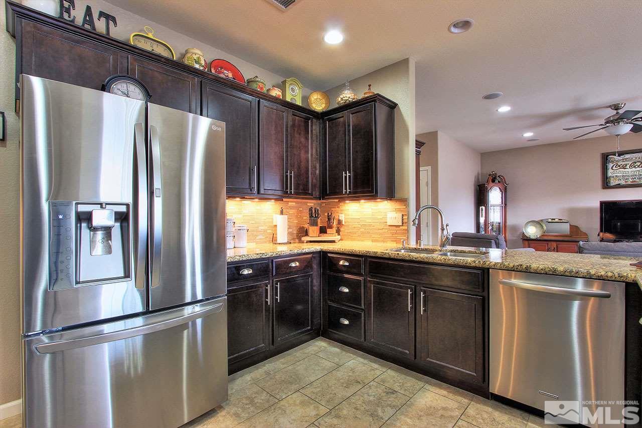 9655 Aidan Way Reno, NV 89521 - Photo 8 of 25 a kitchen with granite countertop stainless steel appliances a sink and counter space