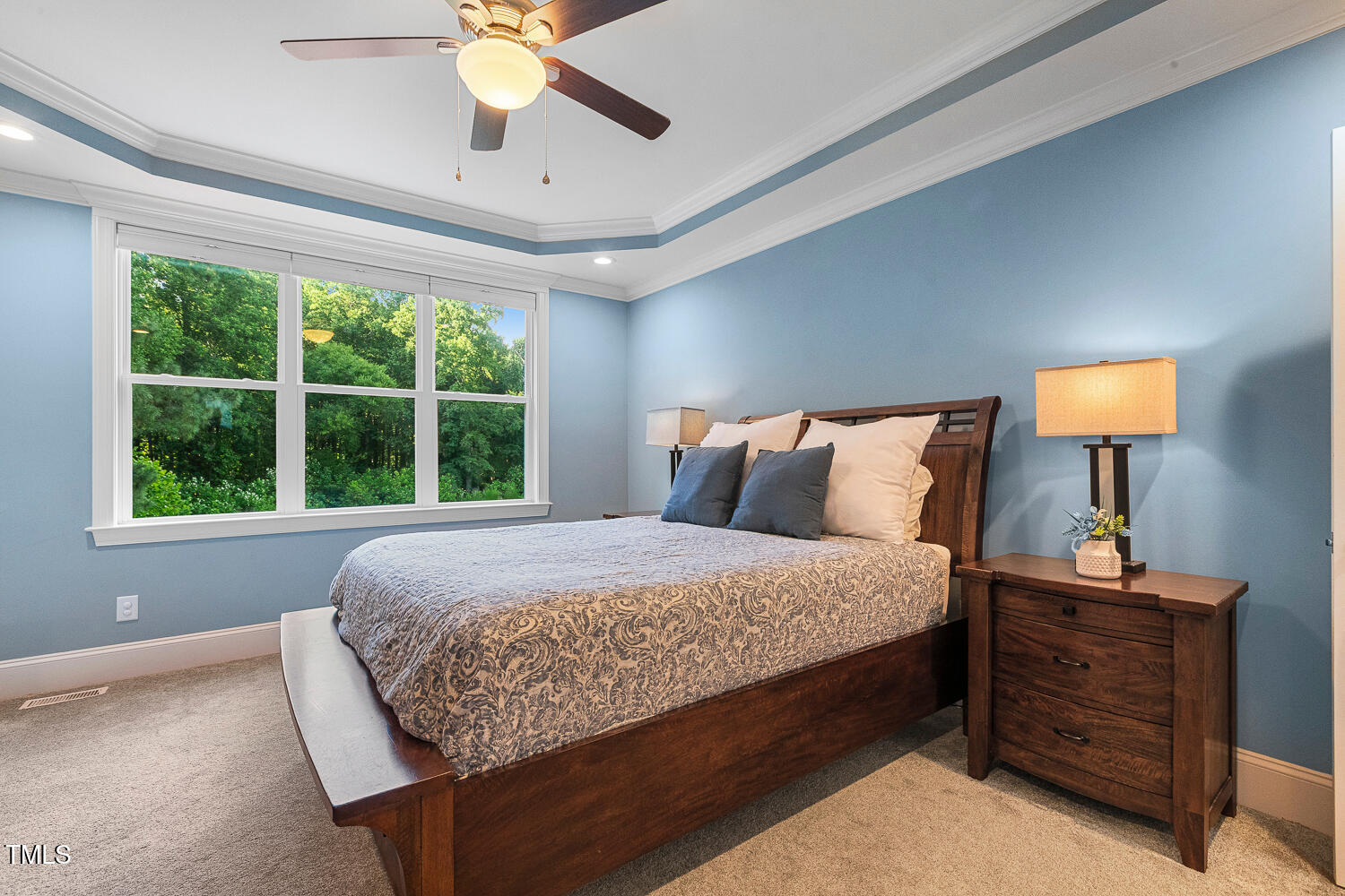 830 Wilbon Road Holly Springs, NC 27540 - Photo 25 of 60 a bed sitting in a bedroom next to a window