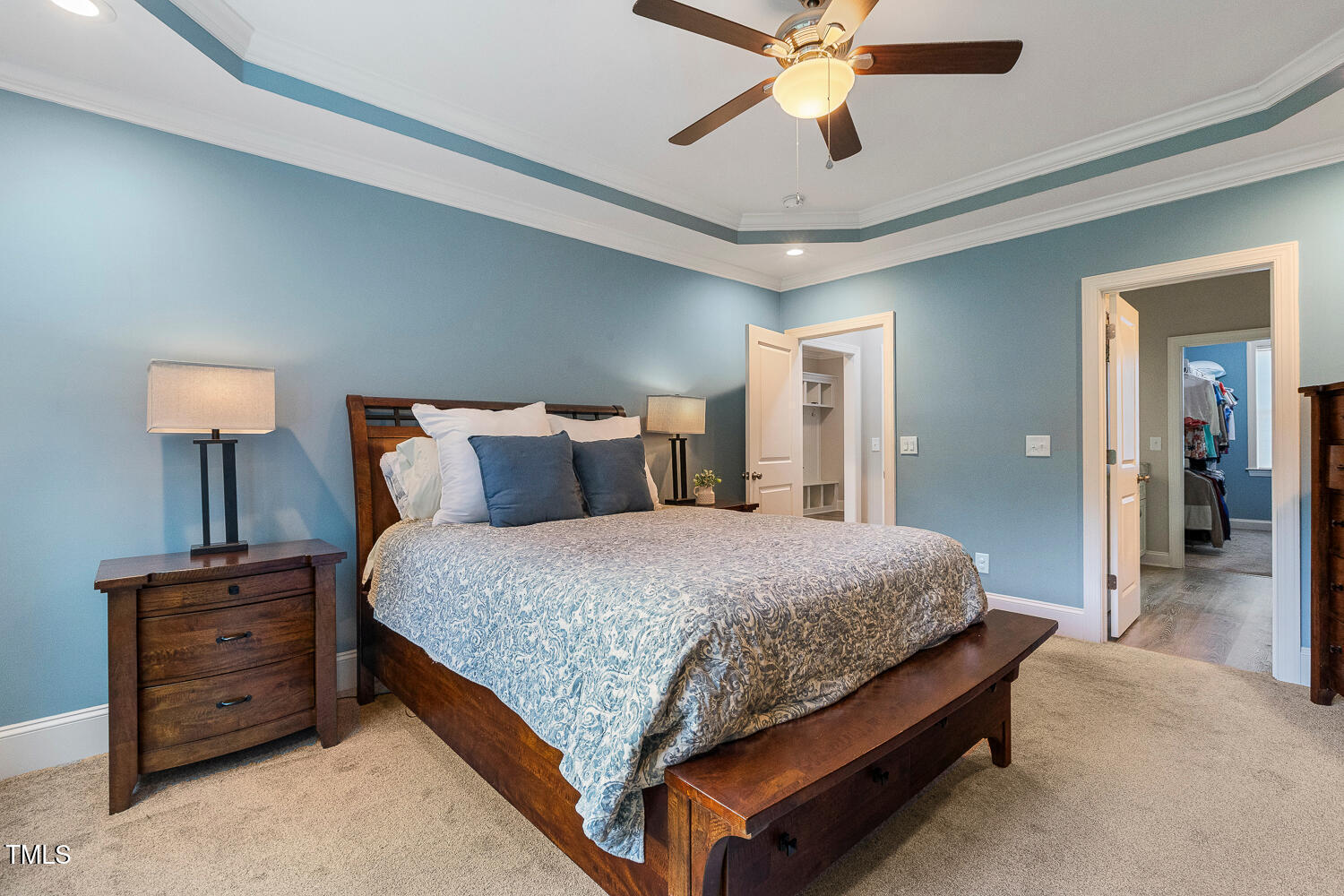 830 Wilbon Road Holly Springs, NC 27540 - Photo 26 of 60 a bedroom with a bed and a chandelier