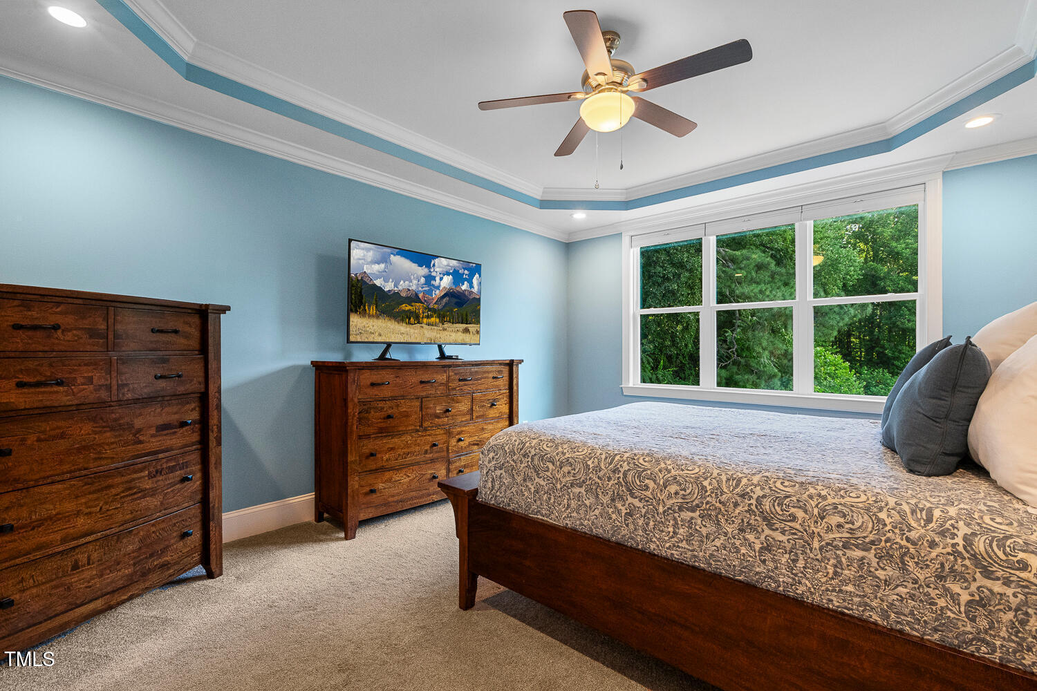830 Wilbon Road Holly Springs, NC 27540 - Photo 27 of 60 a bedroom with a bed and a dresser next to a window