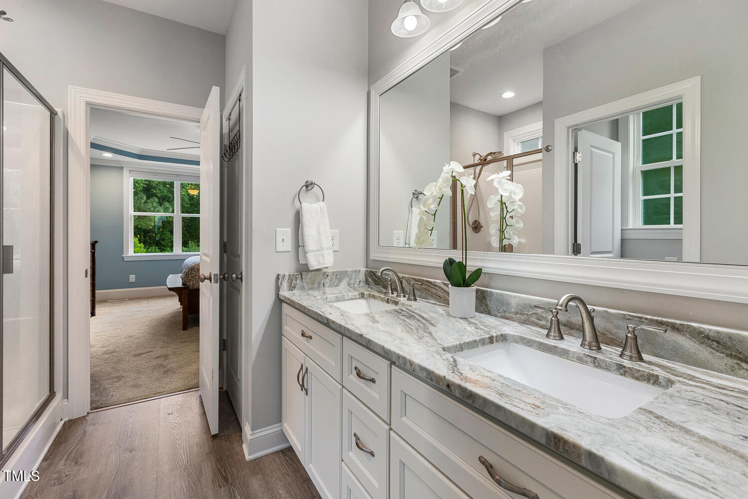 830 Wilbon Road Holly Springs, NC 27540 - Photo 29 of 60 a en suite bathroom with a granite countertop sink and a large mirror