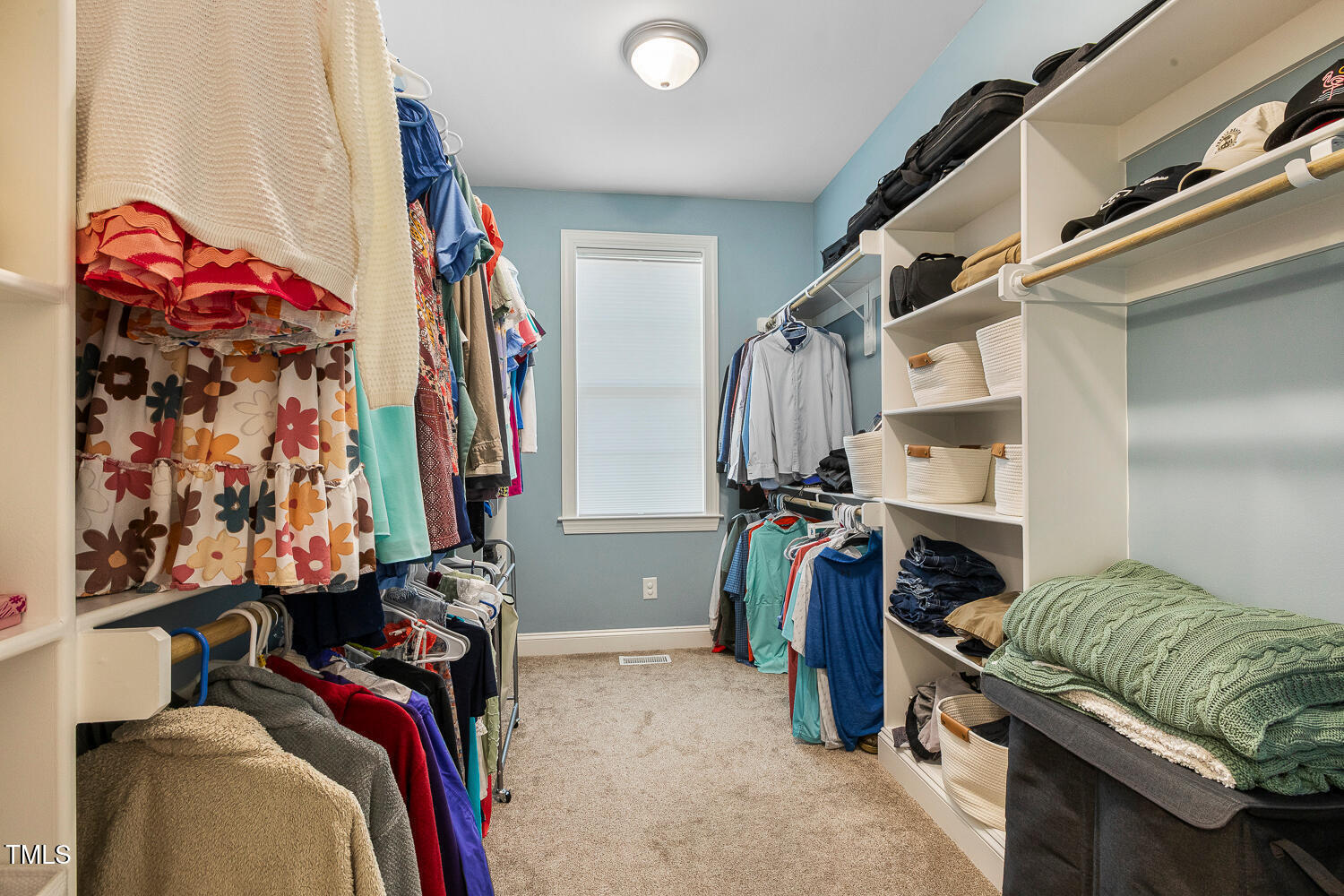 830 Wilbon Road Holly Springs, NC 27540 - Photo 32 of 60 a view of walk in closet with clothes and shoes