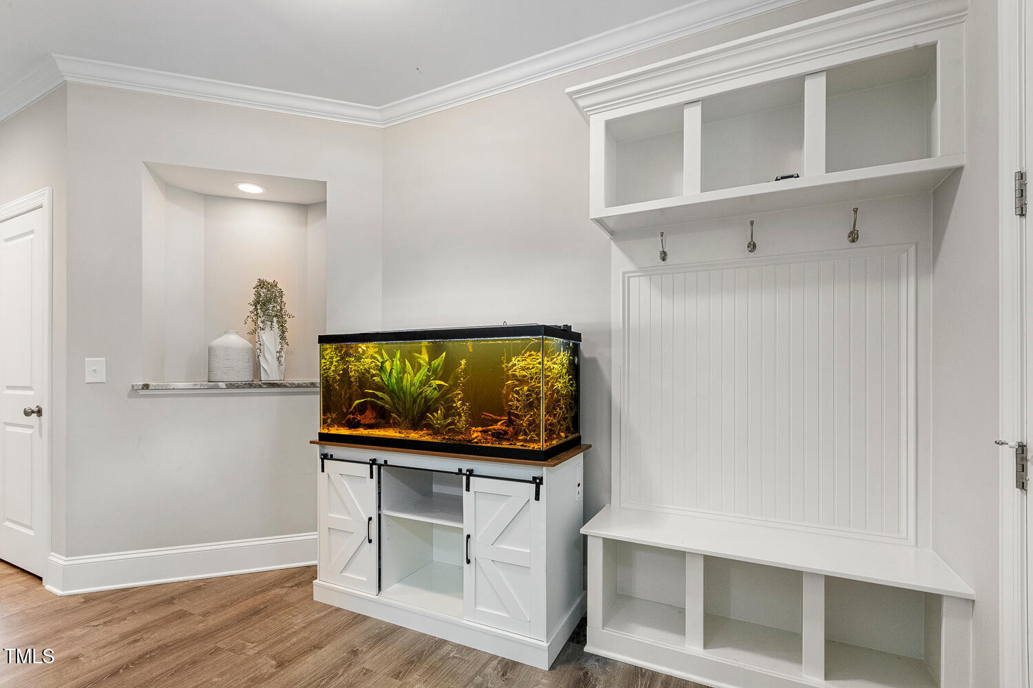 830 Wilbon Road Holly Springs, NC 27540 - Photo 34 of 60 a living room with flat screen tv dressers and white wooden floor