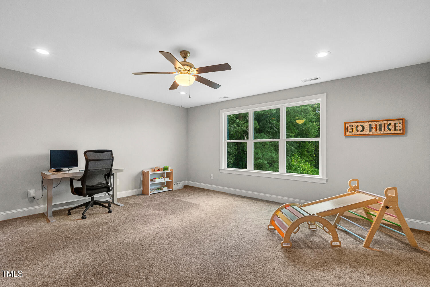 830 Wilbon Road Holly Springs, NC 27540 - Photo 46 of 60 a view of a workspace with furniture and a window