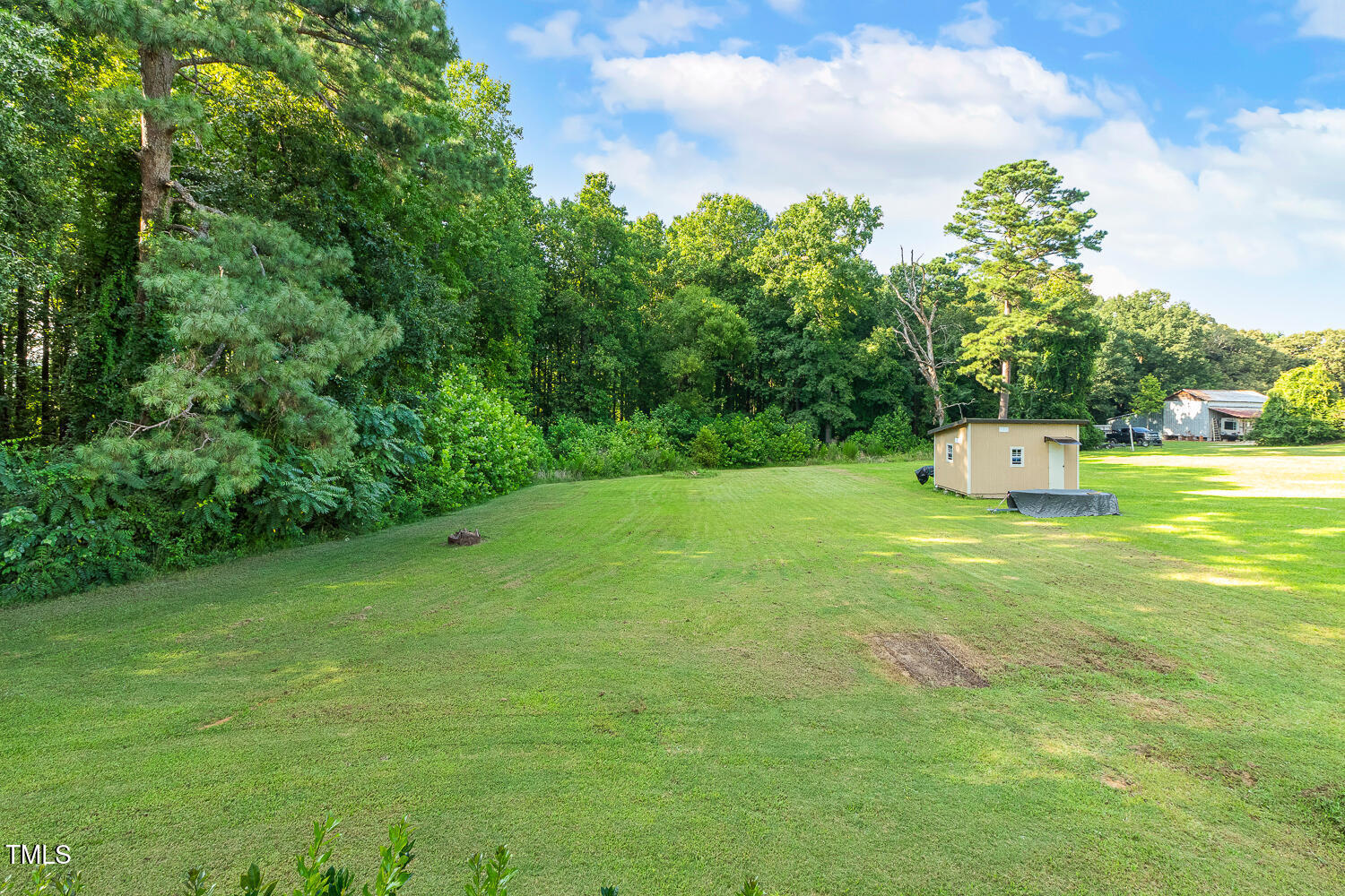 830 Wilbon Road Holly Springs, NC 27540 - Photo 52 of 60 a backyard of a house with lots of green space and garden view
