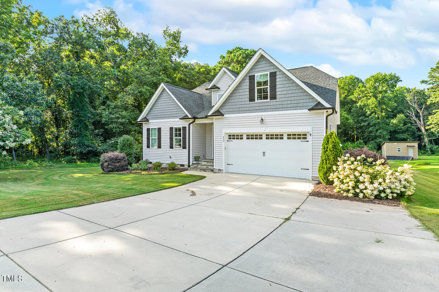 830 Wilbon Road Holly Springs, NC 27540 - Photo 6 of 60 a front view of a house with a yard and garage