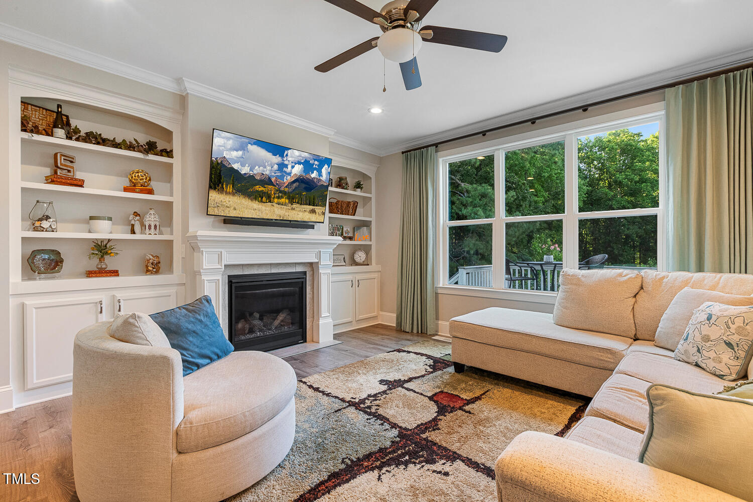 830 Wilbon Road Holly Springs, NC 27540 - Photo 9 of 60 a living room with furniture a fireplace and a large window