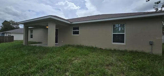 a house with green field in front of it
