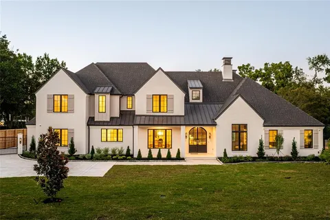 a view of kitchen with stainless steel appliances granite countertop a stove a sink a dining table and chairs
