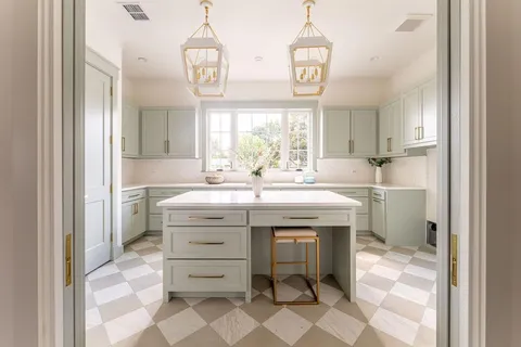 a kitchen with granite countertop white cabinets and a sink