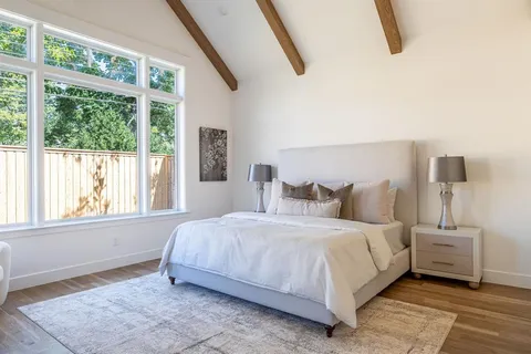 a front view of a house with a garden and yard