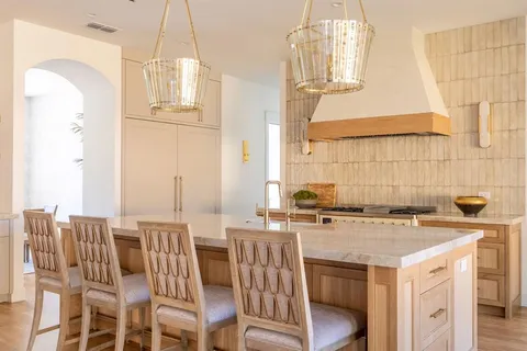 a kitchen with stainless steel appliances kitchen island granite countertop a refrigerator and a stove