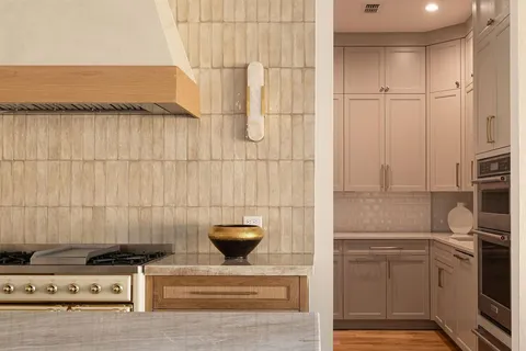a kitchen with cabinets appliances and a counter space