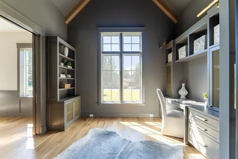 a bedroom with a bed and a large window