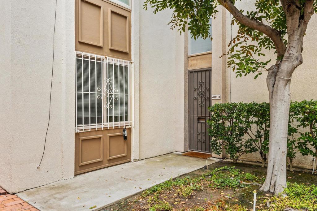 4891 Collwood Boulevard, Unit B San Diego, CA 92115 - Photo 11 of 34 a view of a house with a door and wooden walls