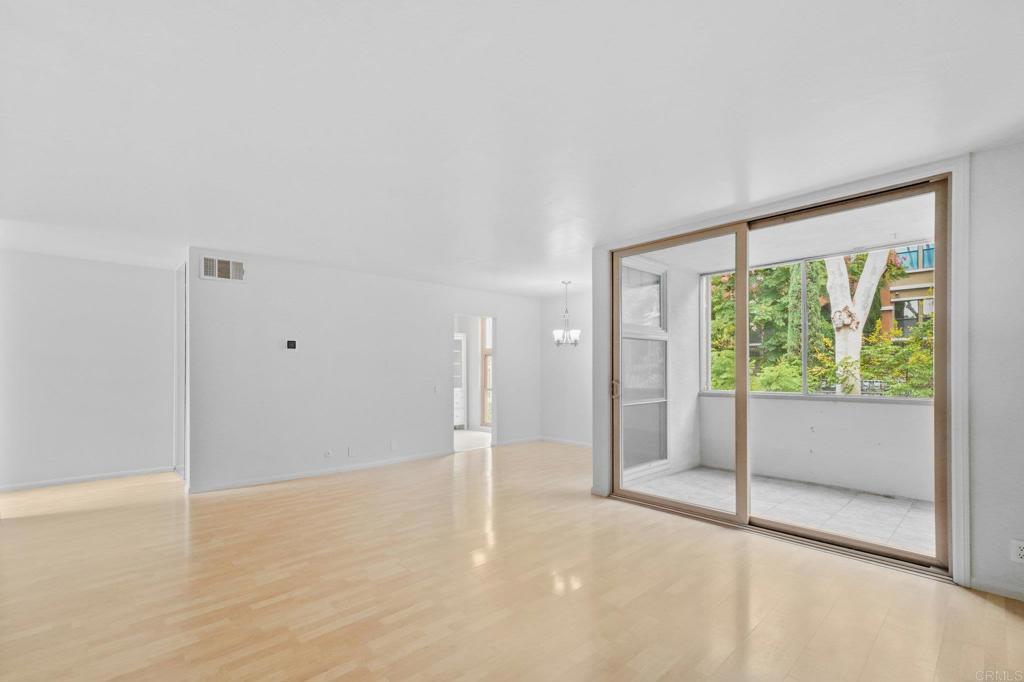 4891 Collwood Boulevard, Unit B San Diego, CA 92115 - Photo 14 of 34 a view of an empty room with wooden floor and a window