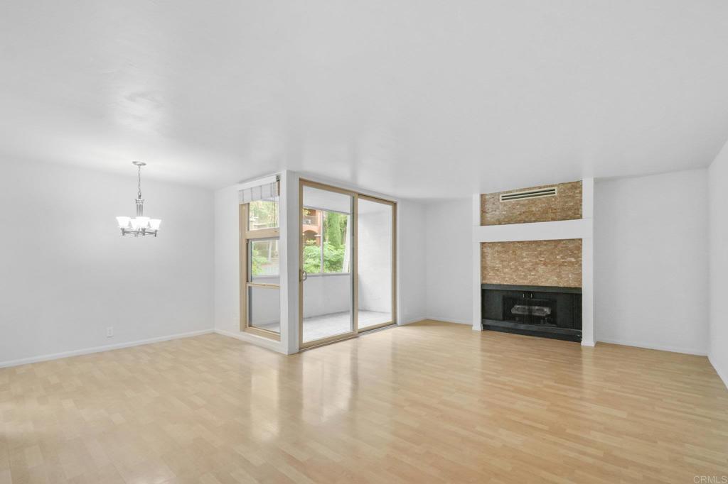 4891 Collwood Boulevard, Unit B San Diego, CA 92115 - Photo 2 of 34 wooden floor in an empty room with a fireplace