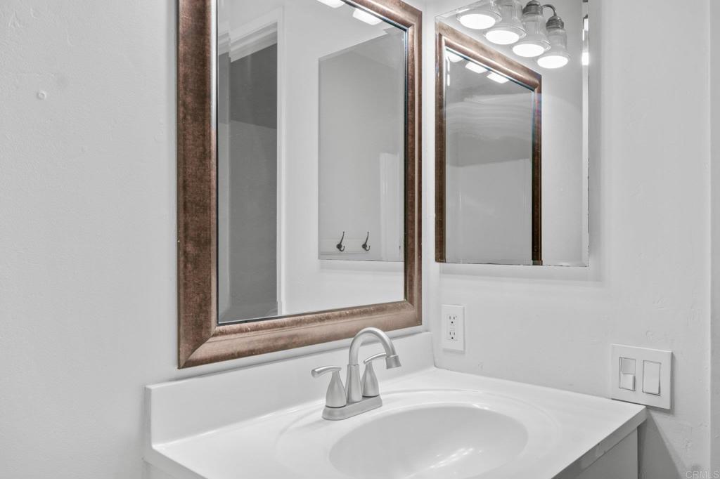 4891 Collwood Boulevard, Unit B San Diego, CA 92115 - Photo 23 of 34 a bathroom with a sink and a mirror