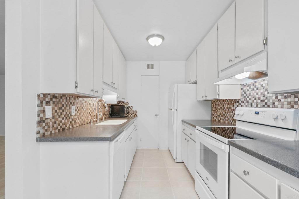 4891 Collwood Boulevard, Unit B San Diego, CA 92115 - Photo 6 of 34 a kitchen with stainless steel appliances granite countertop a sink and a stove