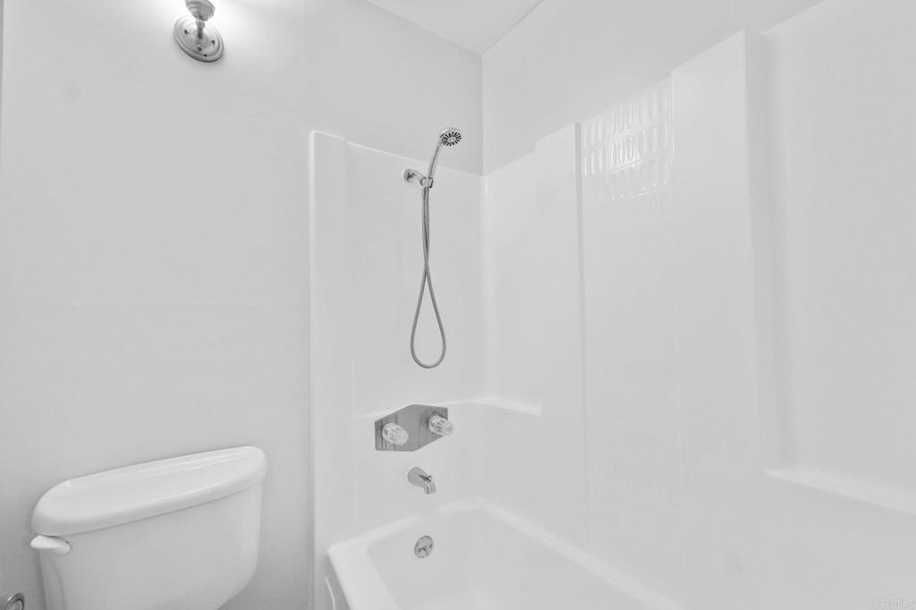 4891 Collwood Boulevard, Unit B San Diego, CA 92115 - Photo 8 of 34 a bathroom with a shower and toilet