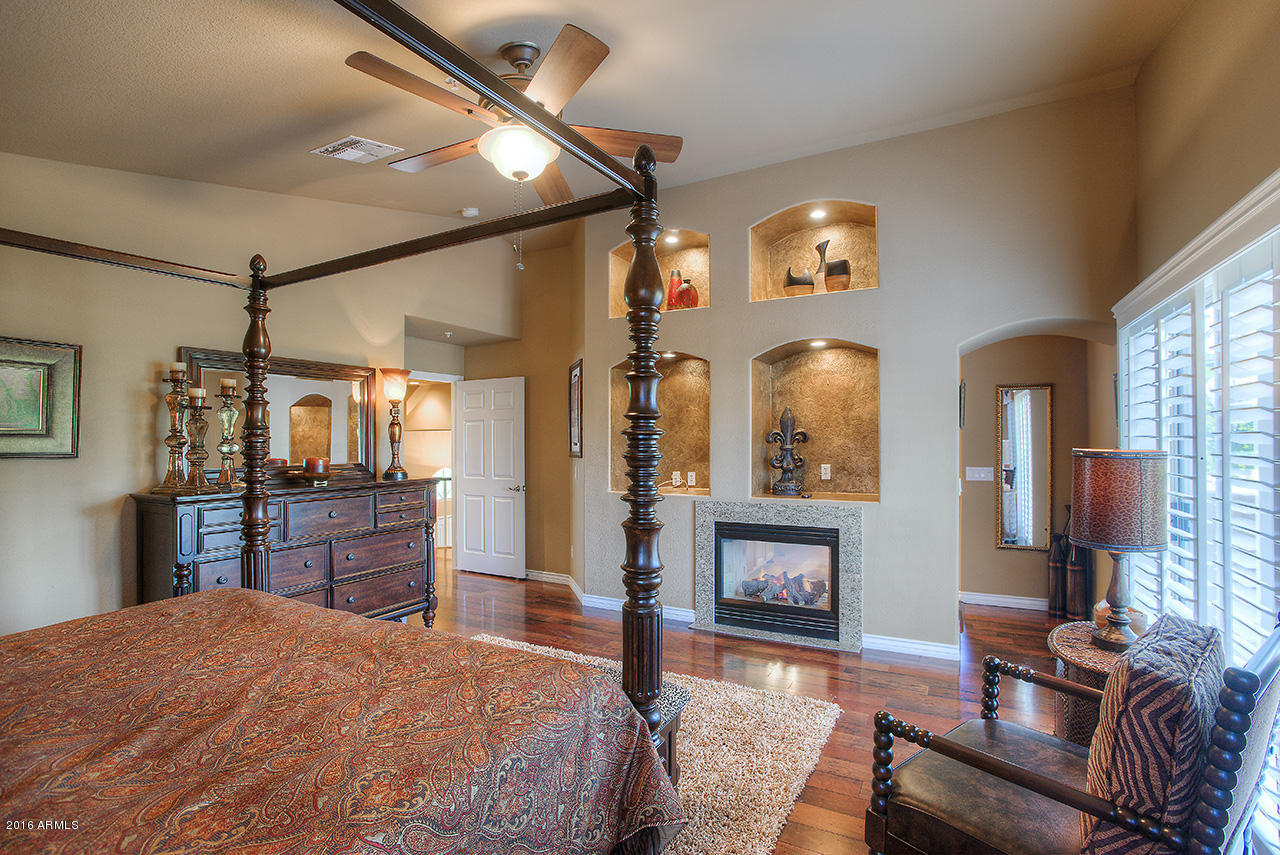 7532 East Alameda Road Scottsdale, AZ 85255 - Photo 14 of 27 a bedroom with furniture a bed and a flat screen tv