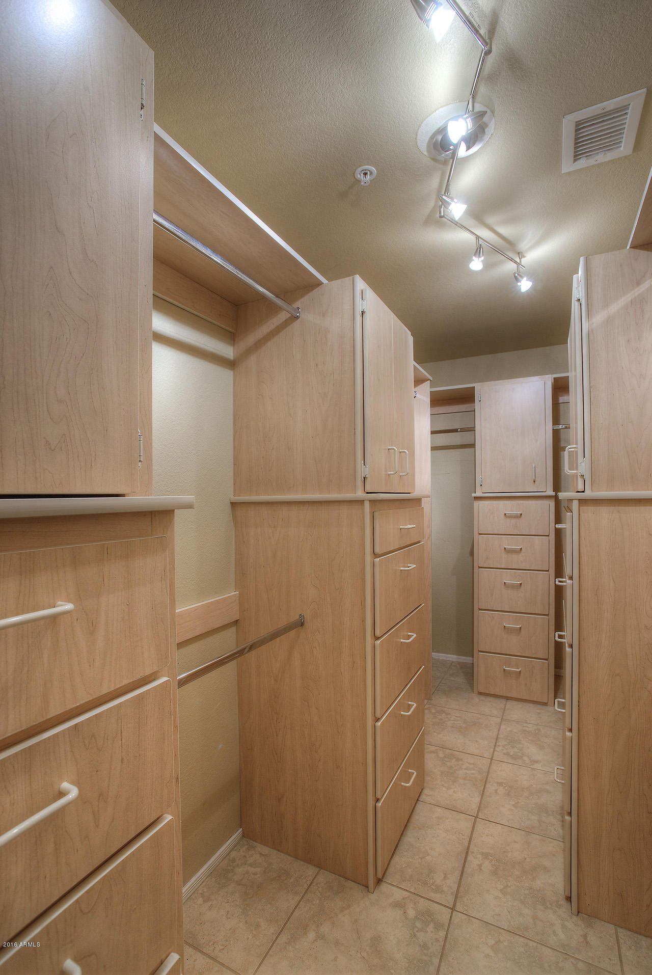 7532 East Alameda Road Scottsdale, AZ 85255 - Photo 17 of 27 a storage room with cabinets