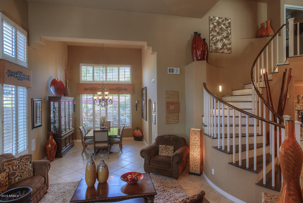 7532 East Alameda Road Scottsdale, AZ 85255 - Photo 2 of 27 a living room with furniture and a large window