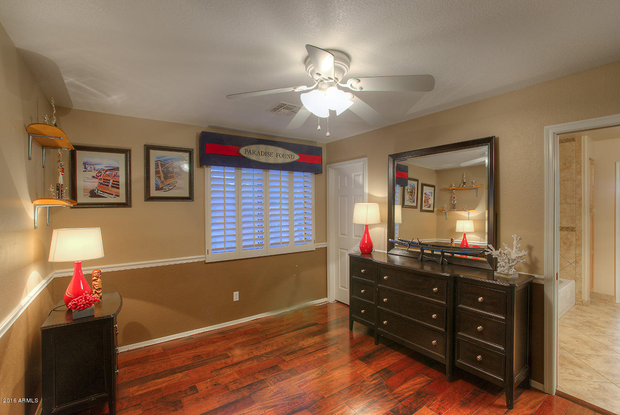 7532 East Alameda Road Scottsdale, AZ 85255 - Photo 22 of 27 a room that has a dresser and a mirror in it