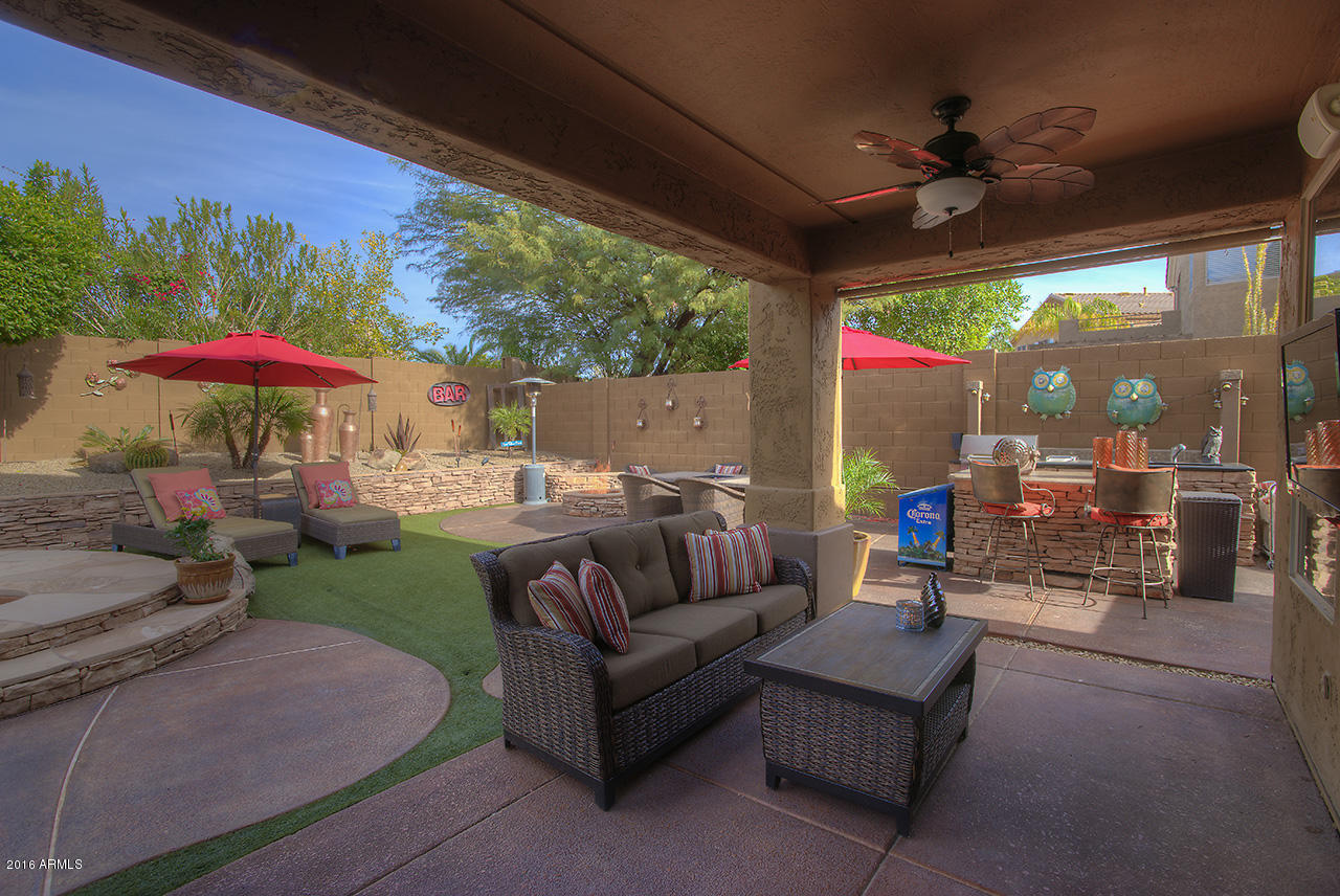 7532 East Alameda Road Scottsdale, AZ 85255 - Photo 23 of 27 a patio with a table and chairs under an umbrella