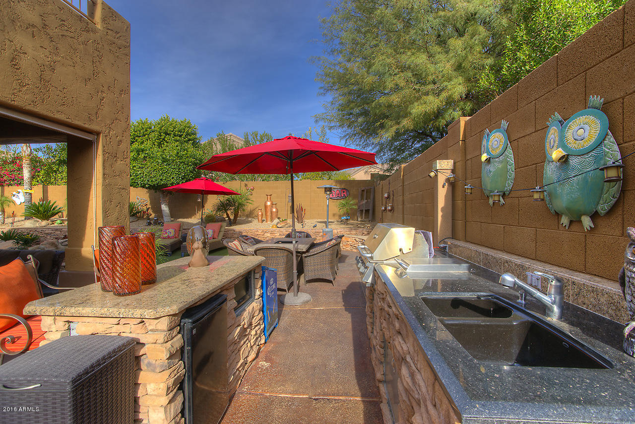 7532 East Alameda Road Scottsdale, AZ 85255 - Photo 24 of 27 an outdoor sitting area with furniture and umbrella