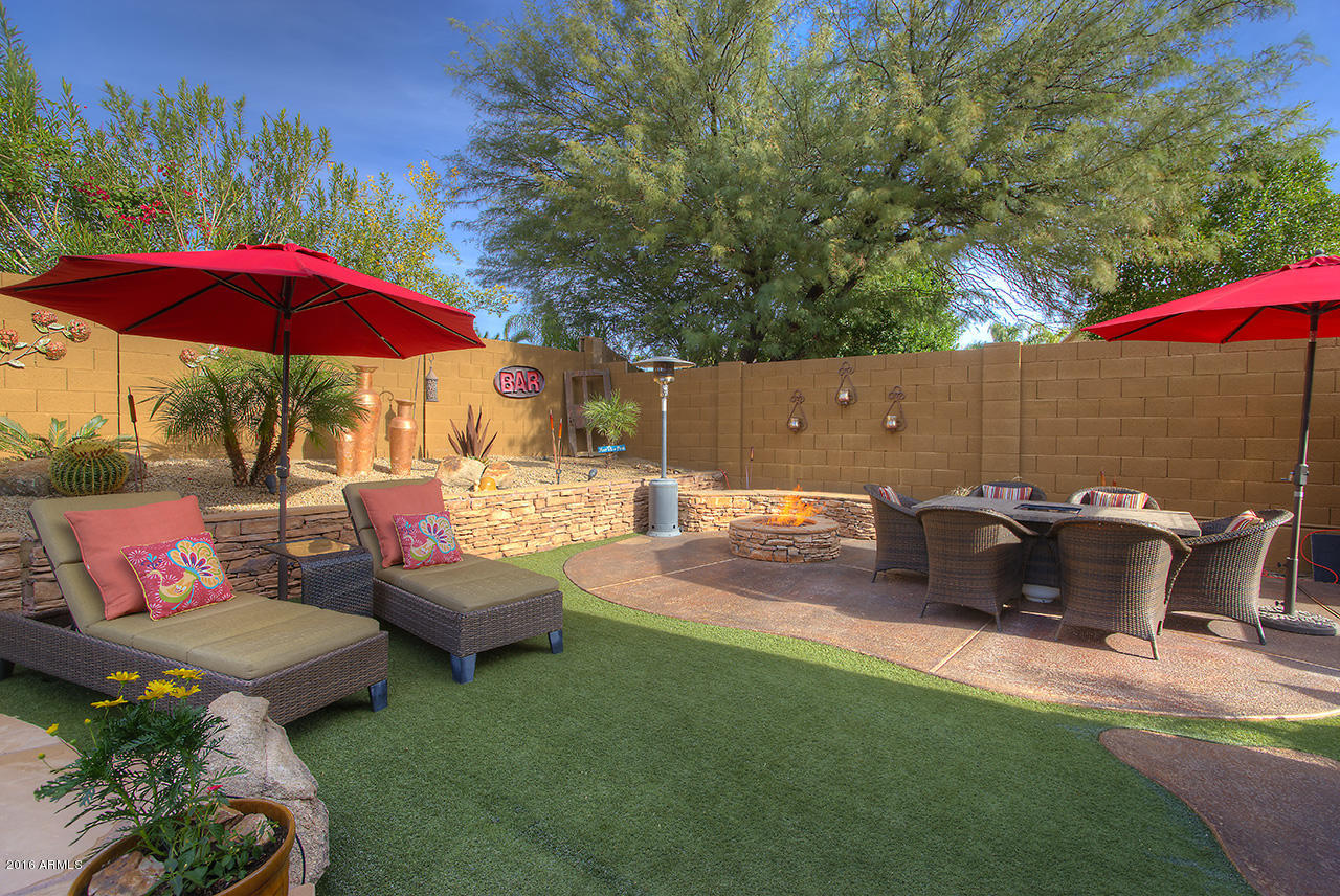 7532 East Alameda Road Scottsdale, AZ 85255 - Photo 26 of 27 a view of a patio with table and chairs under an umbrella