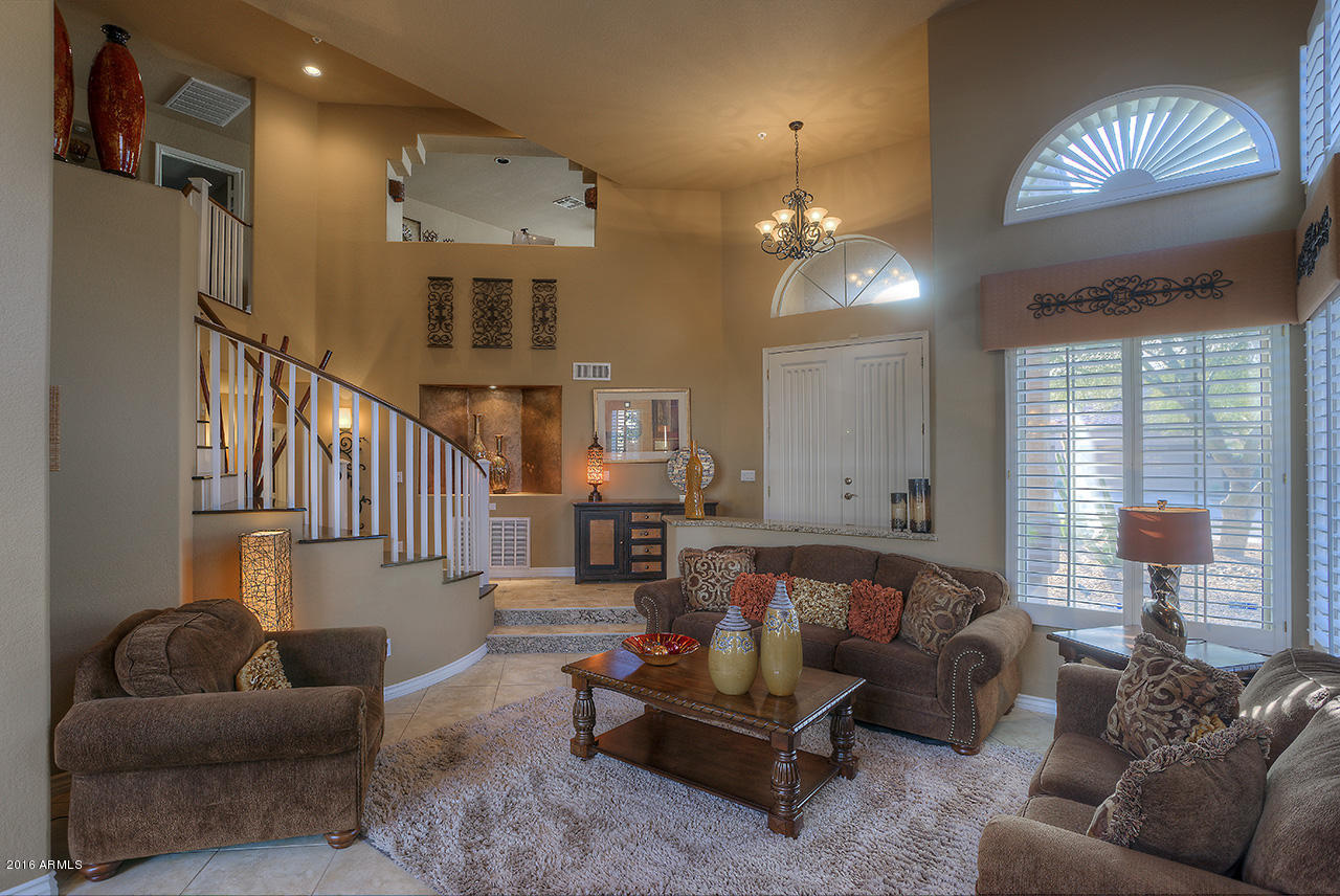 7532 East Alameda Road Scottsdale, AZ 85255 - Photo 3 of 27 a living room with furniture and a chandelier