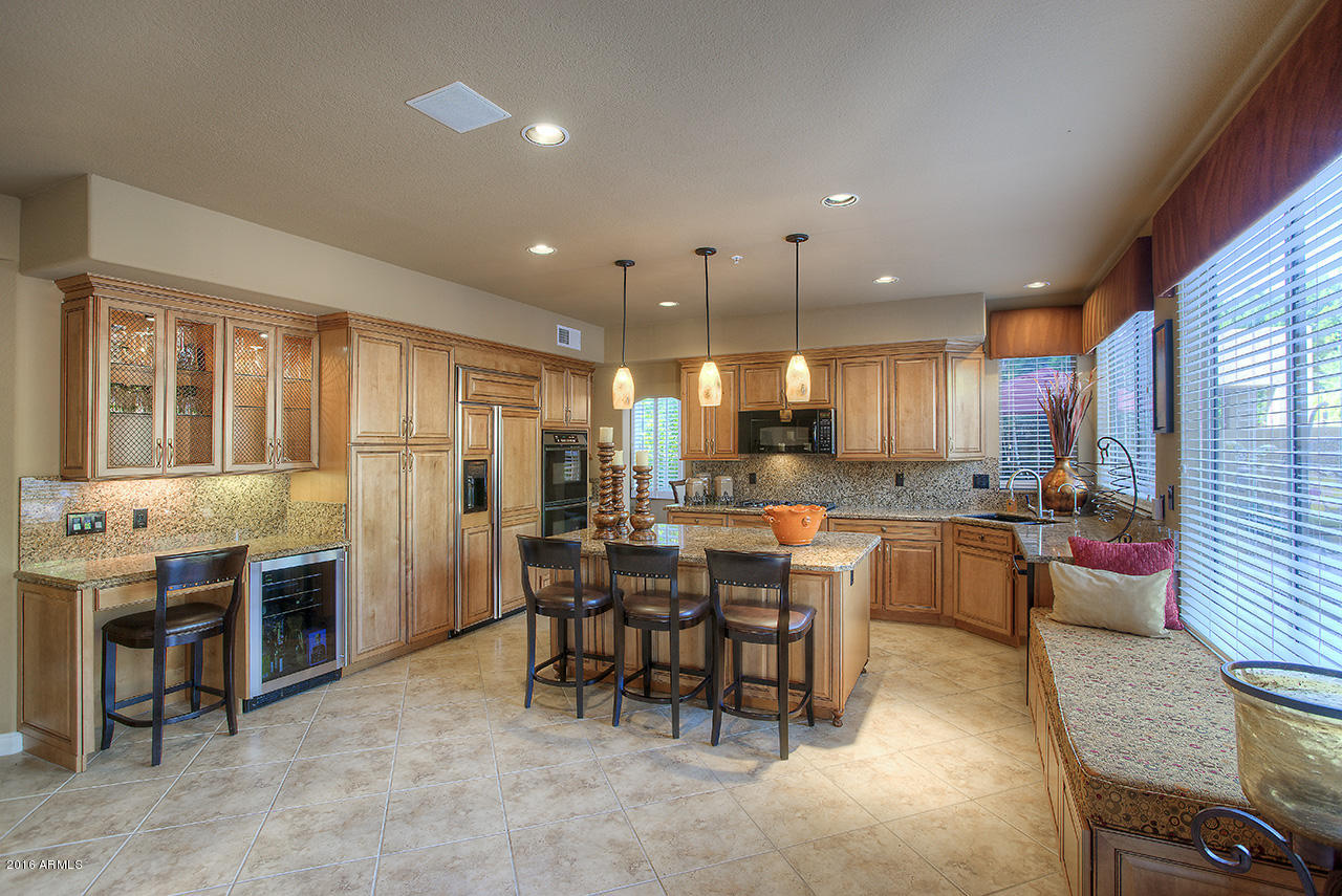7532 East Alameda Road Scottsdale, AZ 85255 - Photo 5 of 27 a large kitchen with lots of counter space dining table and chairs