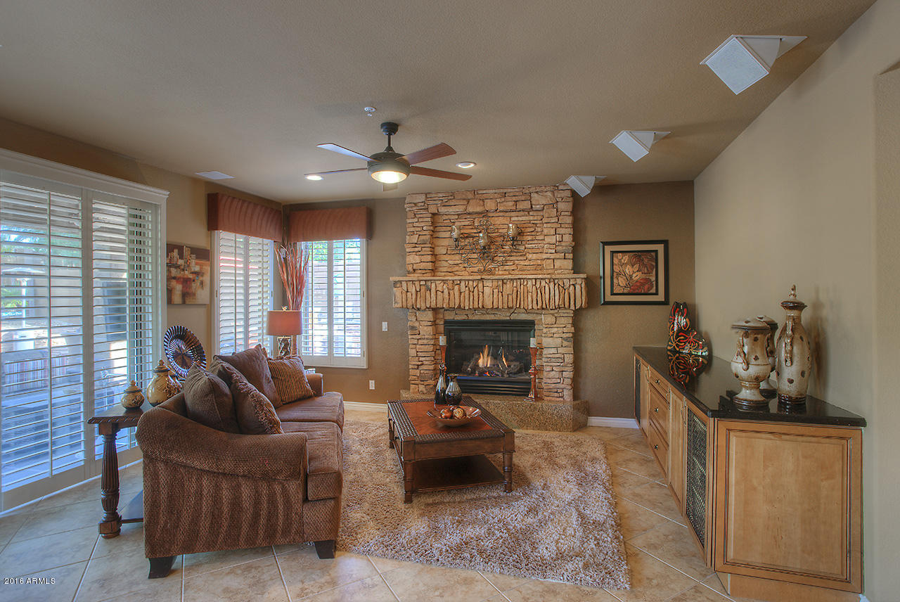 7532 East Alameda Road Scottsdale, AZ 85255 - Photo 7 of 27 a living room with furniture and a fireplace