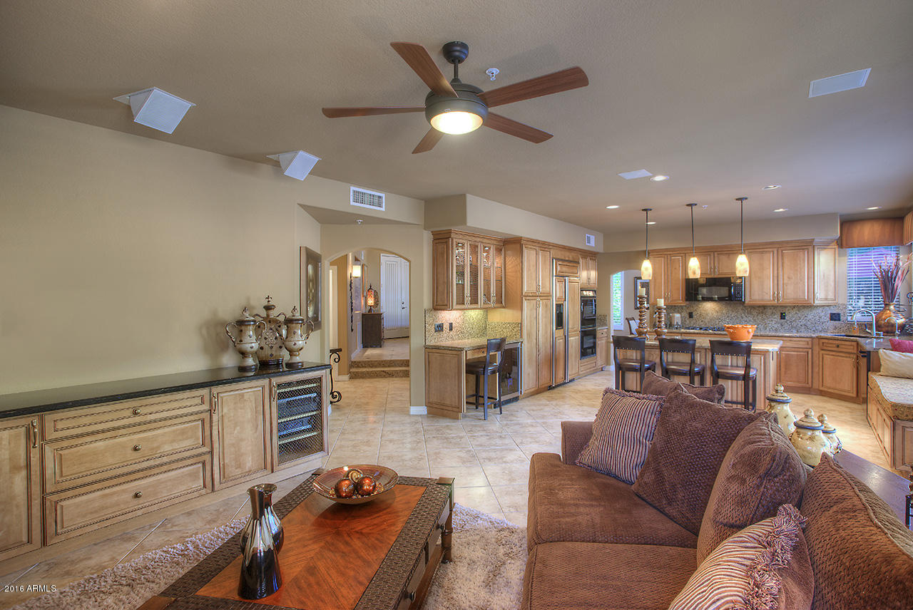 7532 East Alameda Road Scottsdale, AZ 85255 - Photo 8 of 27 a living room with furniture kitchen view and a chandelier