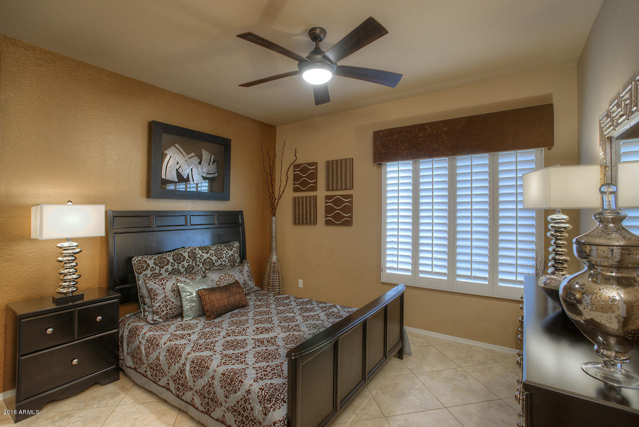 7532 East Alameda Road Scottsdale, AZ 85255 - Photo 9 of 27 a bedroom with a bed and a chandelier