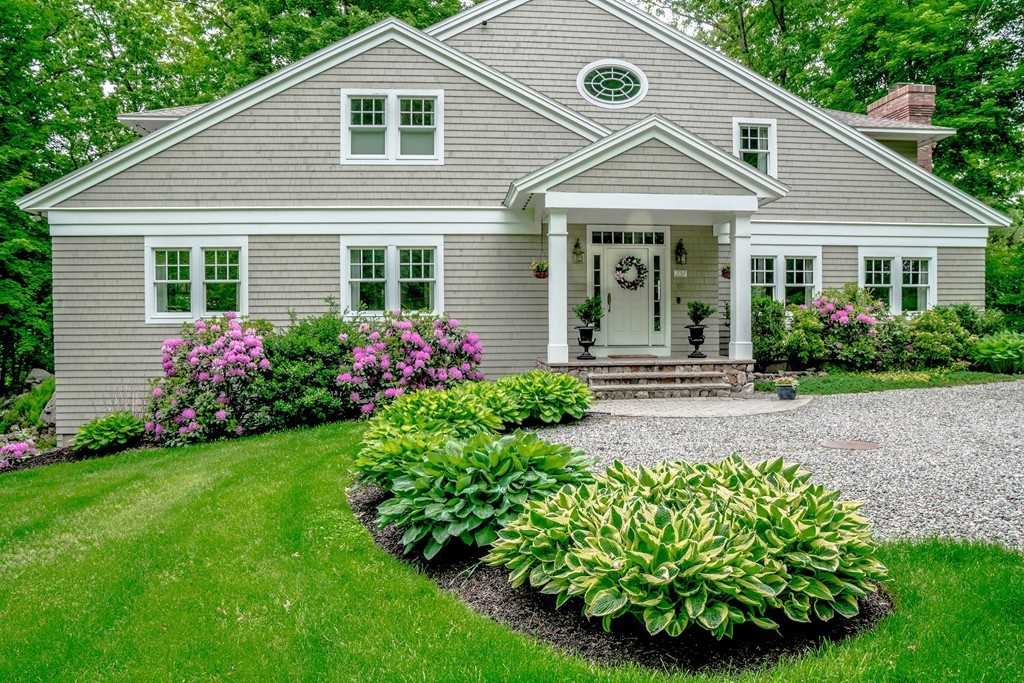 a front view of a house with garden